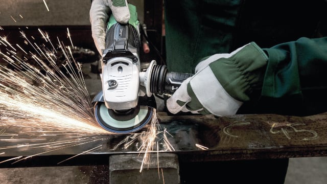 Angle grinder with sparks over steel